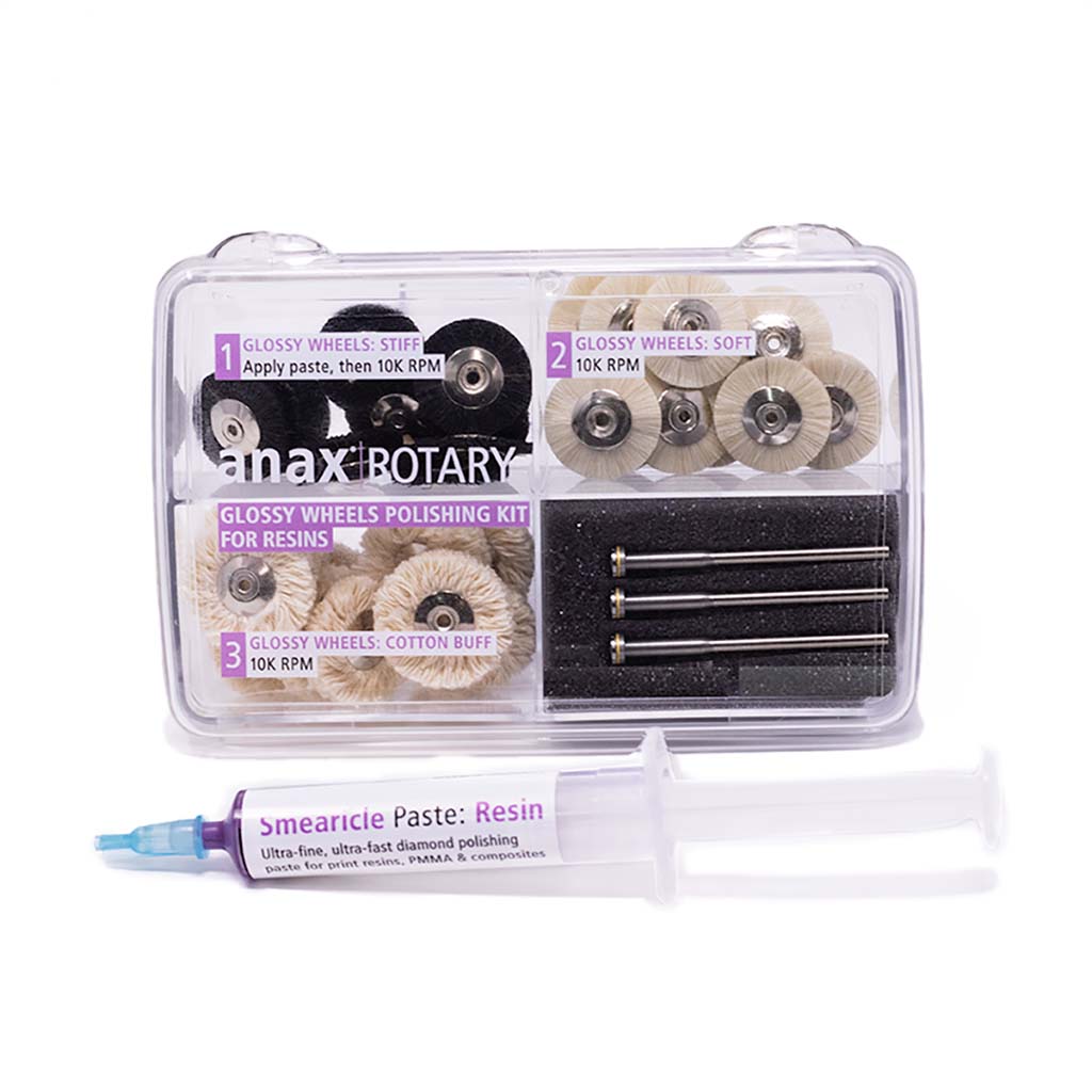anax Rotary Glossy Wheels Polishing Kit for Resins, in a clear box with four compartments. Contains stiff wheels, soft wheels, cotton buff wheels, and 3 bur mandrels. Also contains a syringe of anax USA Smearicle Paste for resin.