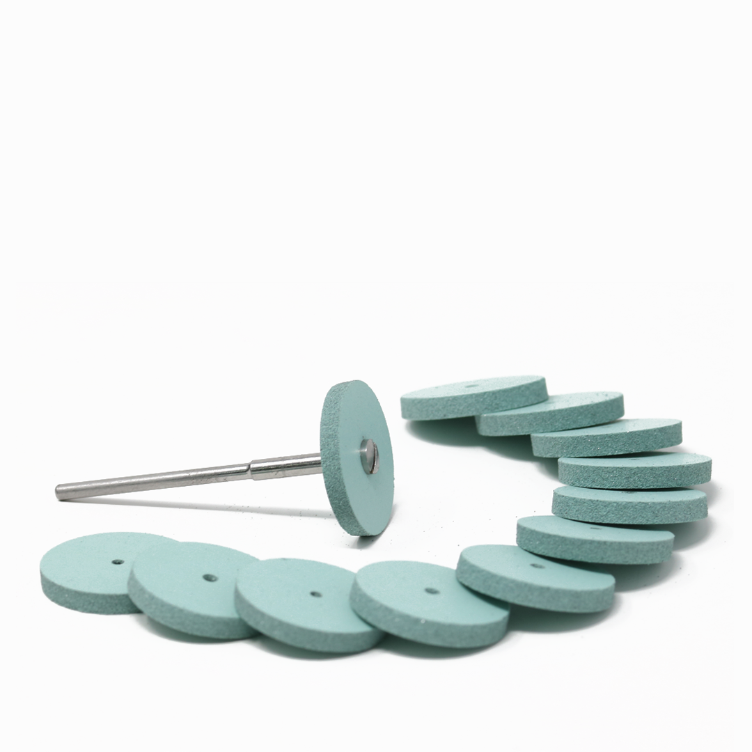 Set of twelve blue polishing wheels on a white background; one has a mandrel attached.