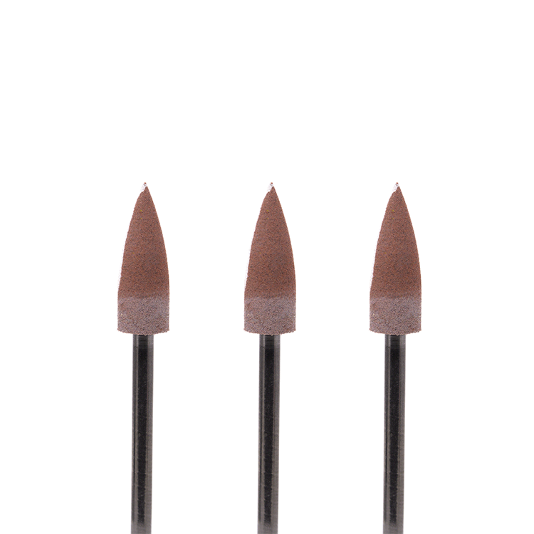 Set of three red-and-white colored pointed rotary burs on a white background.
