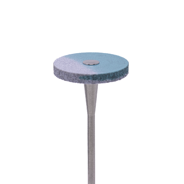 A blue-and-white colored disc-shaped rotary bur on a white background.