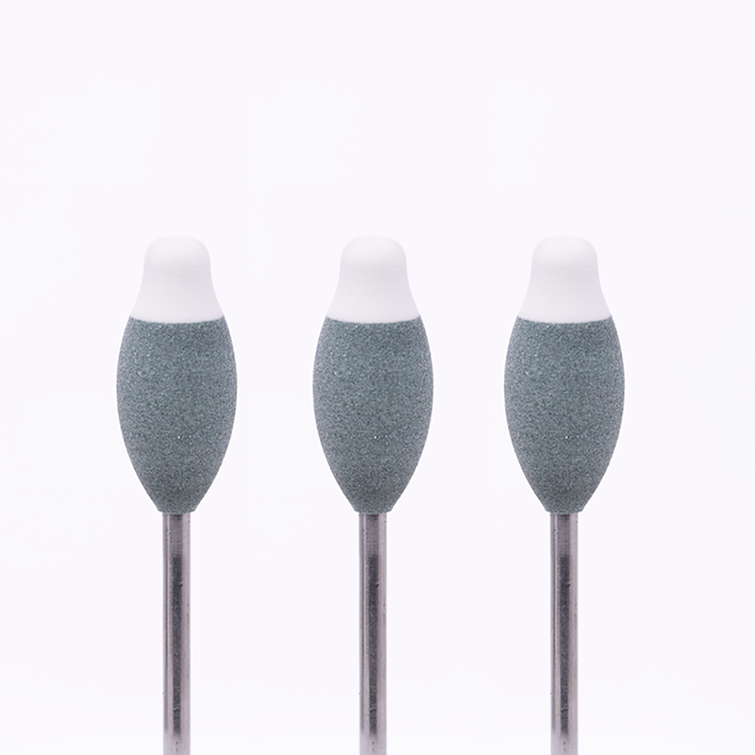 Set of three grey rotary burs with white tips on a white background.