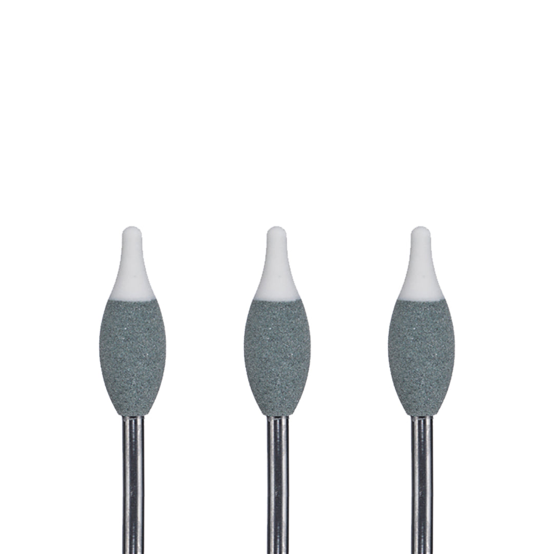 Set of three grey rotary burs with white tips on a white background.