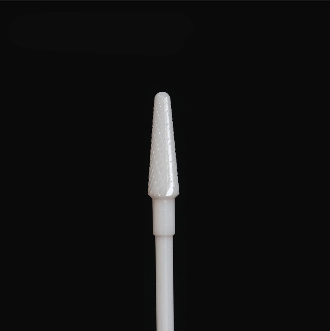 White rotary bur on a black background.