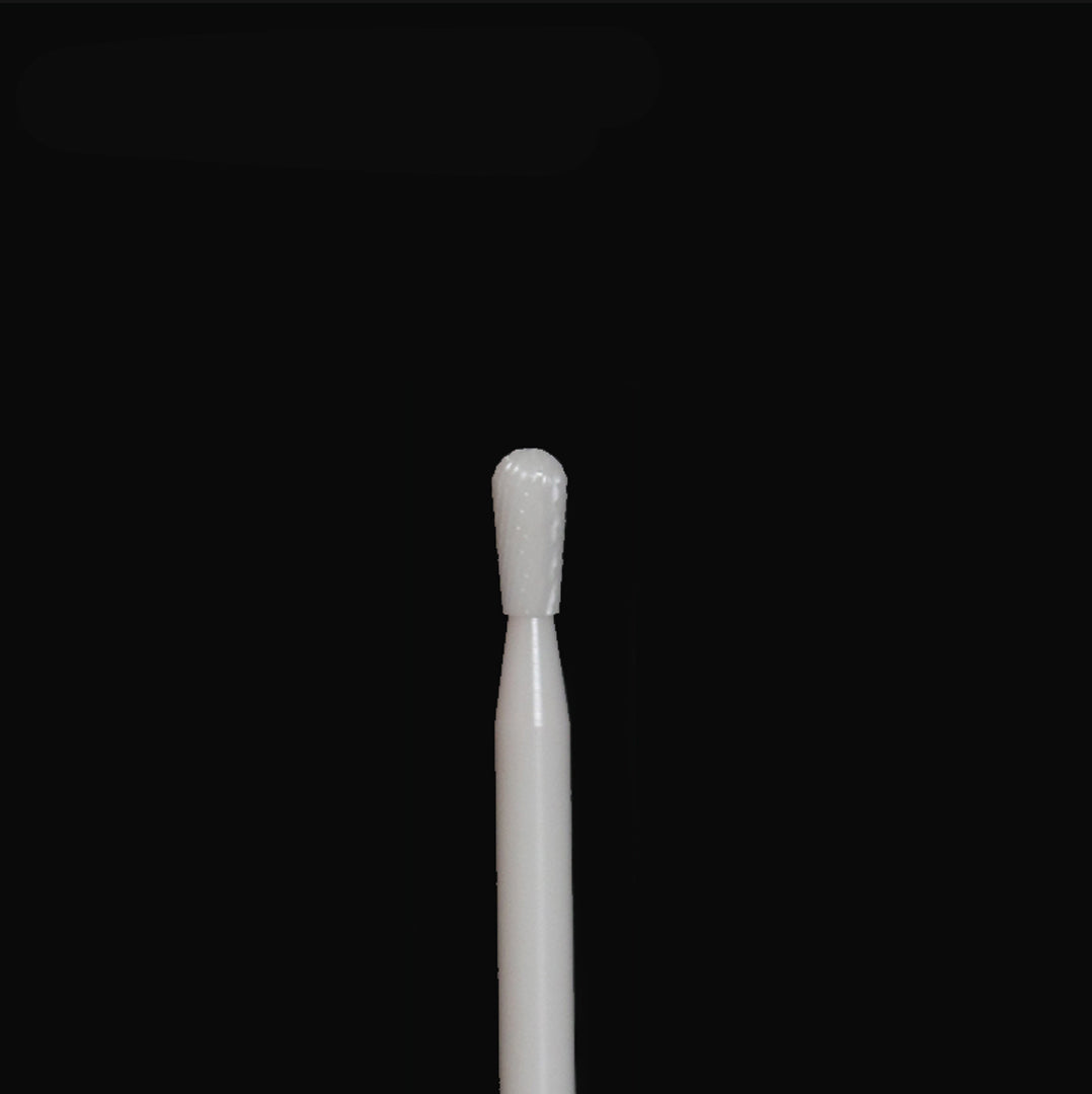 A white rotary bur on a black background.