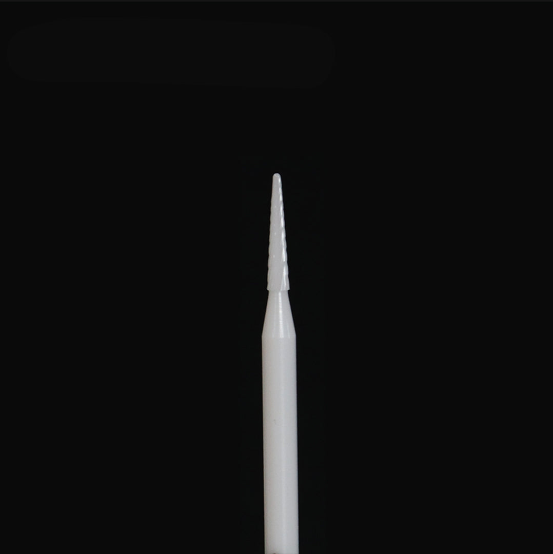 White rotary bur on a black background.