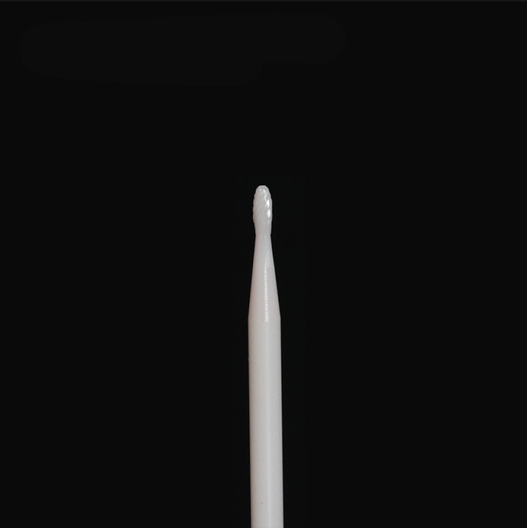 White rotary bur on a black background.
