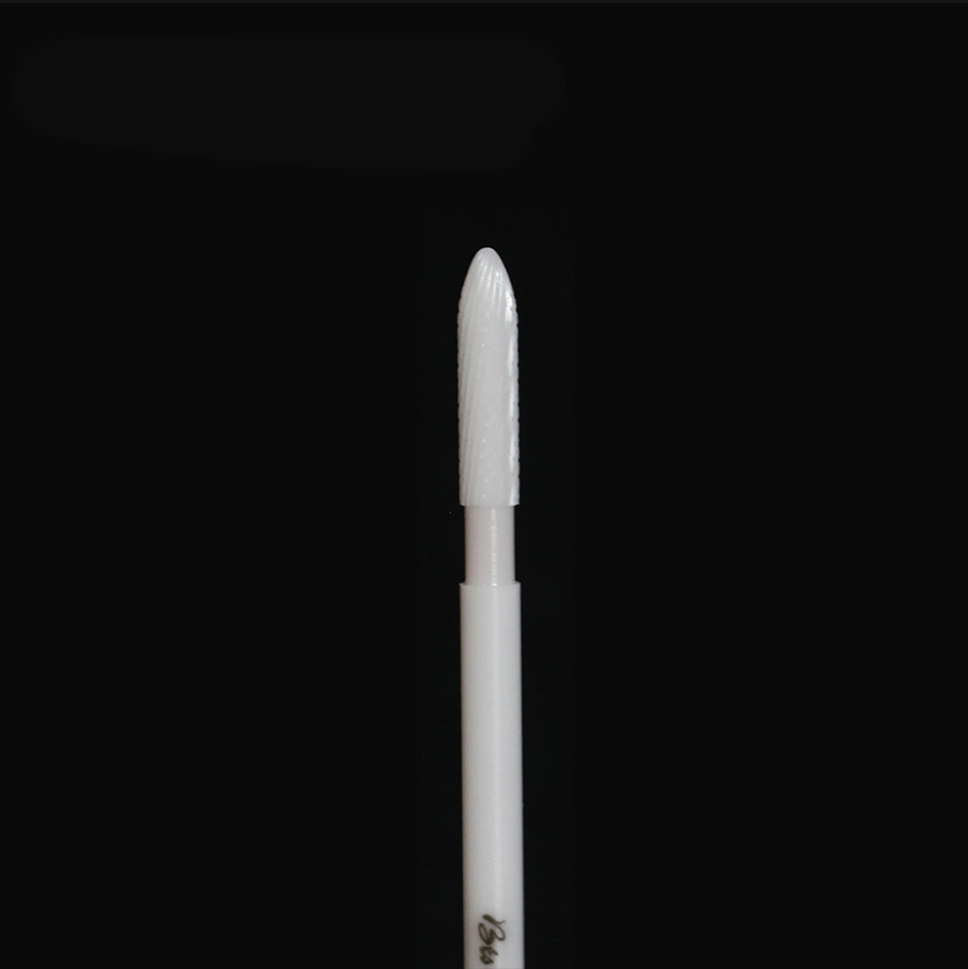 White rotary bur on a black background.