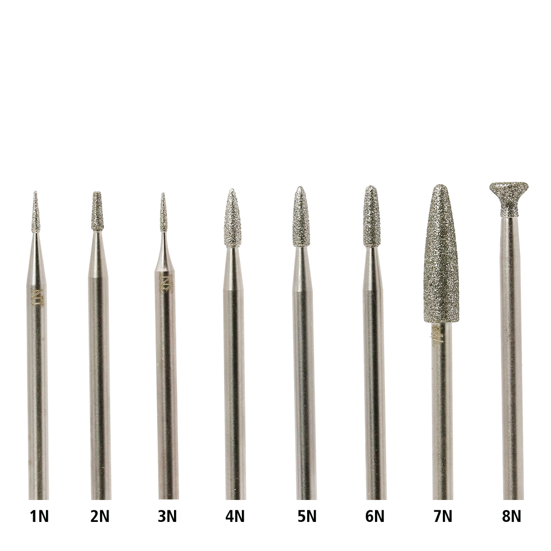 Set of eight diamond rotary burs, each with differently shaped and sized points, on a white background.