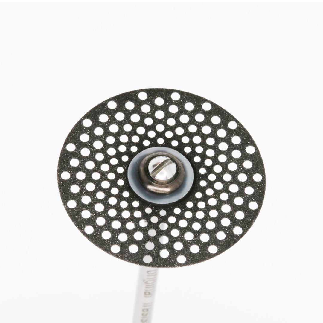 Angled top view of a thin sintered diamond disc attached to a mandrel.