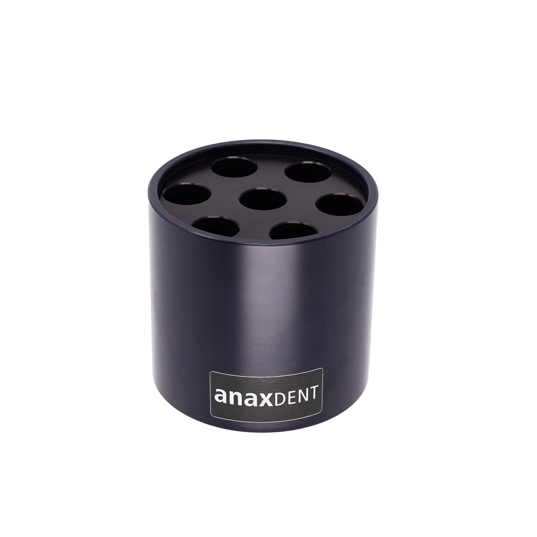 A black composite warmer top designed for holding and warming syringes, with multiple holes on the lid for syringe placement, and the brand name 'anaxdent' visible.