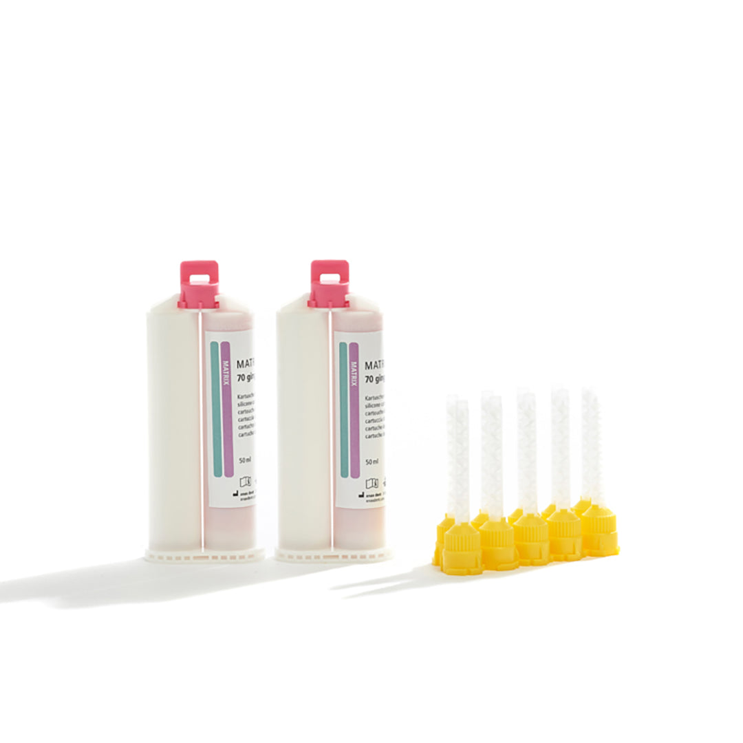 Two cartridges of anaxdent Matrix Flow Gingiva Pink 70 and tips on a white background.