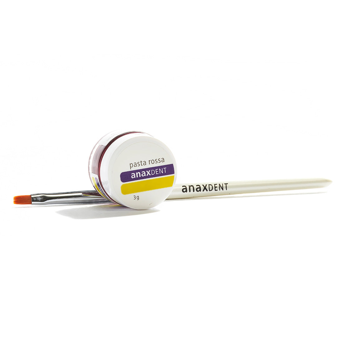 A 3g container of anaxdent Pasta Rossa with a brush behind it on a white background.