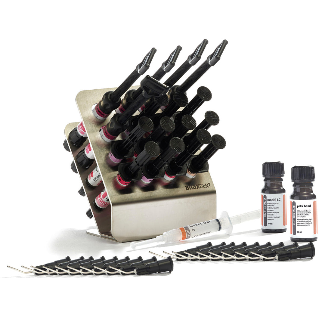 anaxgum syringes arranged in an anaxRACK XXL, with a syringe of Cover Gel, 18 application tips, and bottles of Model LC and Pekk Bond arranged around the rack all on a white background.